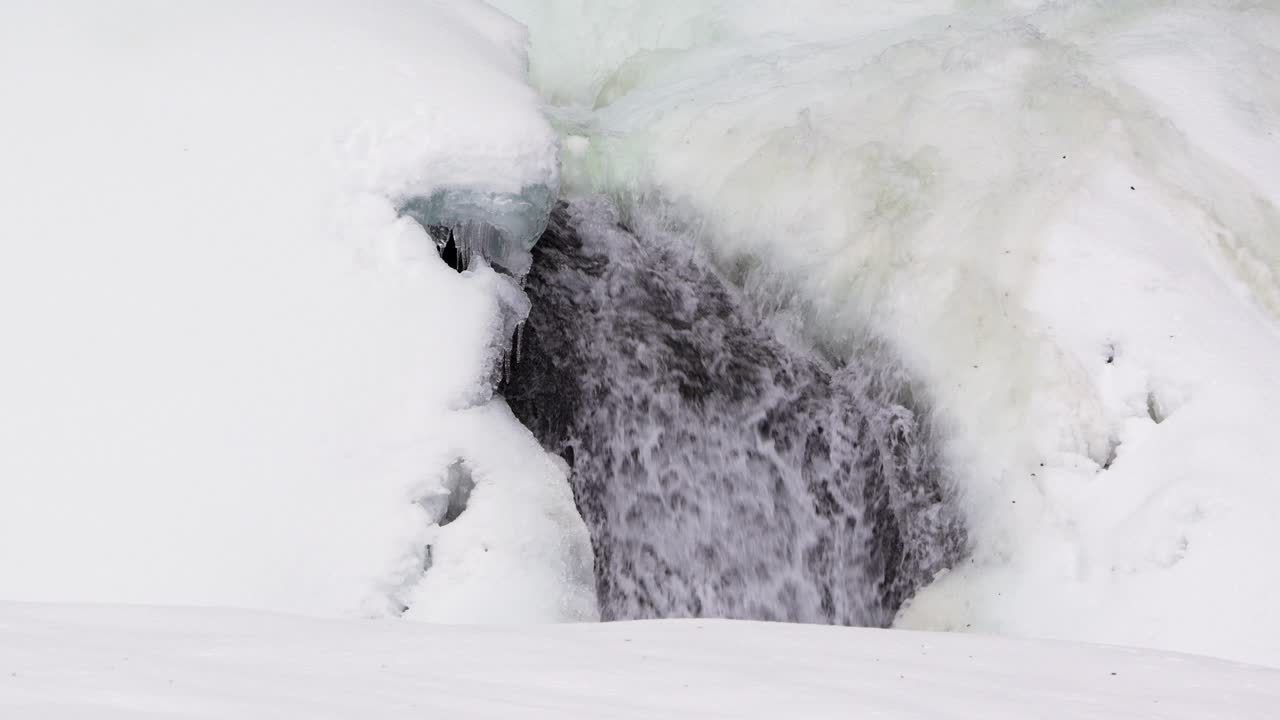 Icy Cascade Carving Through Frozen Ice. Winter Scene