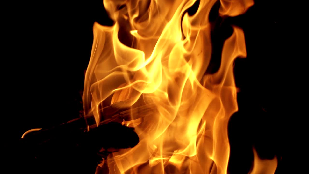 Camp fire in the night. Hot coals in the fire. Slow motion