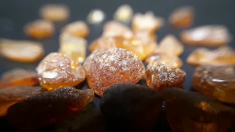 natural baltic amber stones on a black background-1