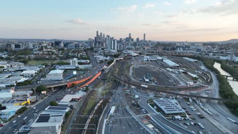 establishing static stationary drone shot of brisbane city, shot during sunset, flying over the inner city bypass icb road network