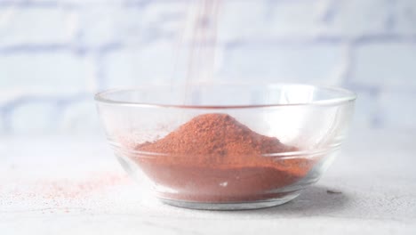 glass bowl with reddish brown powder