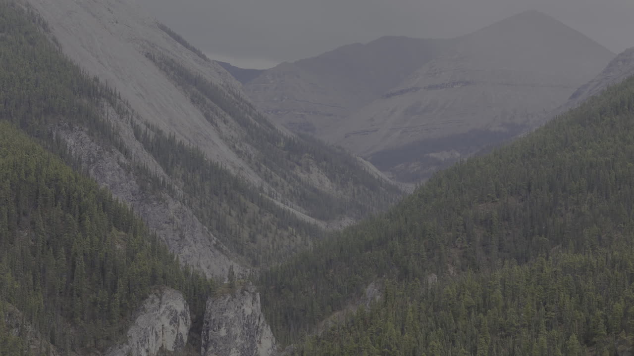 Dramatic mountain landscape with steep, forested ridges.