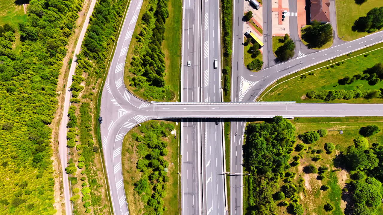 Flight over the highways and freeways with lawns and bushes around. Flight over the road system in the countryside of Slovakia