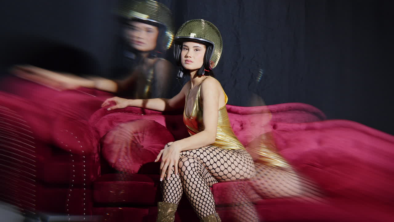 여성이 거울 공 토끼 귀로 포즈를 취합니다.