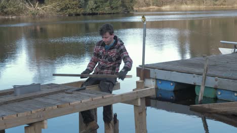 Young-man-planking-wooden-jetty