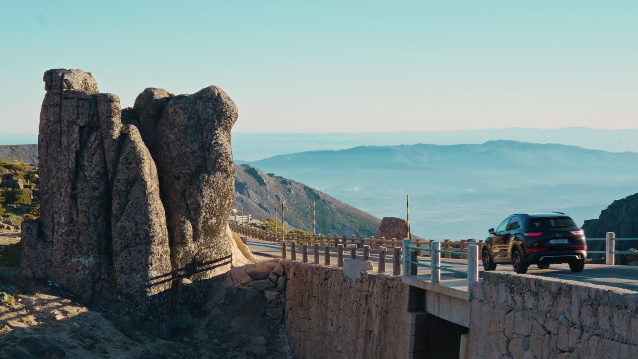 Breathtaking aerial footage of El Roque de los Muchachos, La Palma. Majestic volcanic spires beside a stone path offering sweeping views across the Caldera de Taburiente