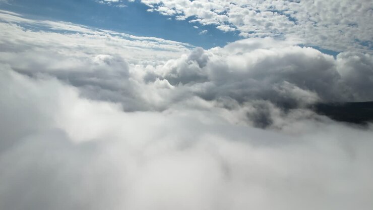 Aerial shot up high in the white clouds