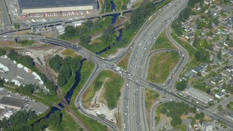 aerial view of busy car traffic on intersection and highway, sunny day