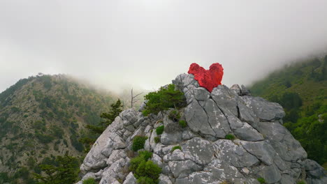 a heart at the peak of a mountain