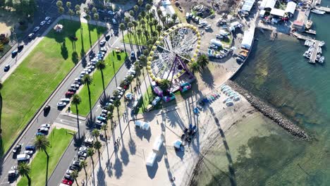drone footage tracking around ferris wheel