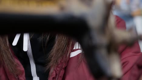 Tilt-down-shot-of-a-beautiful-woman-using-a-sewing-machine-in-slow-motion