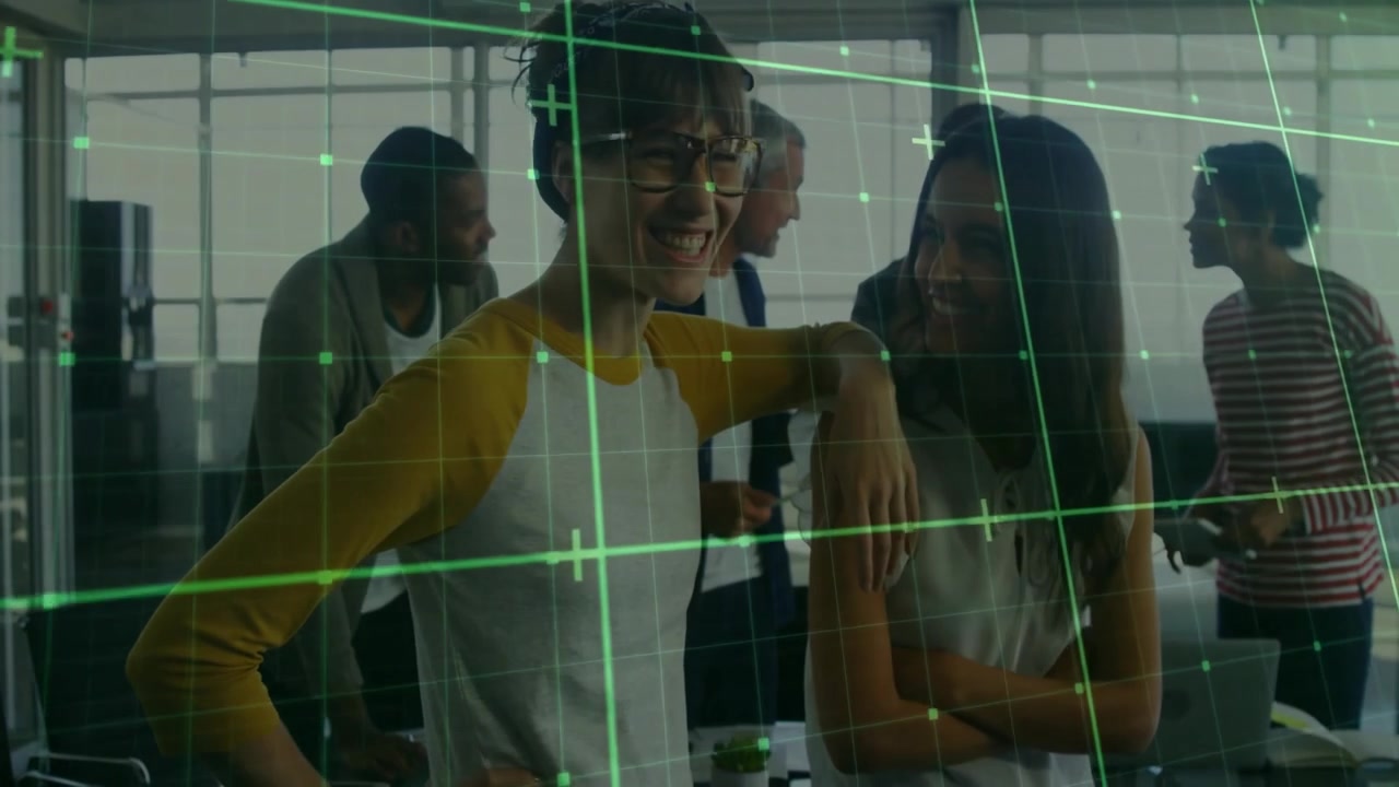After meeting, raglan-sleeve colleague laughing while green grid animating around business desk