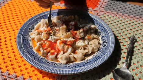 delicious turkish manti dumplings with yogurt and tomato sauce