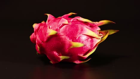 dragon fruit rotates smoothly against a dark backdrop