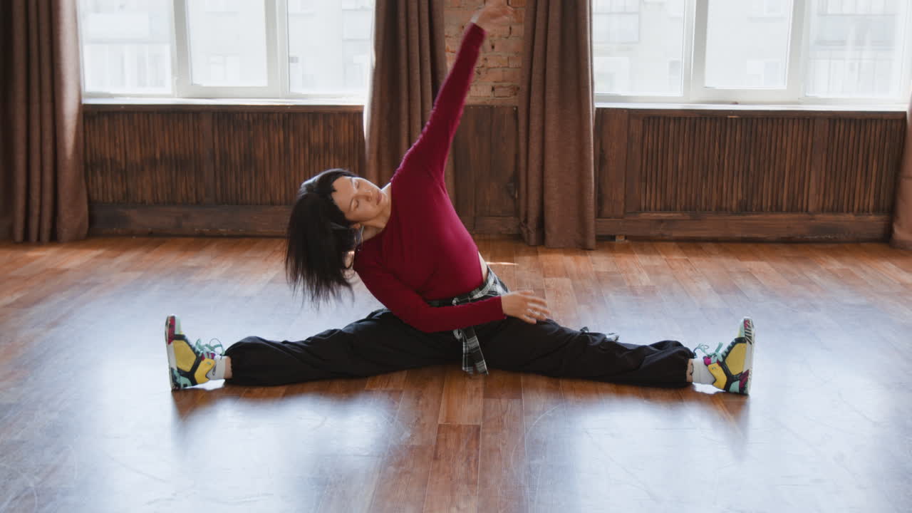 Woman stretching in a split in a studio