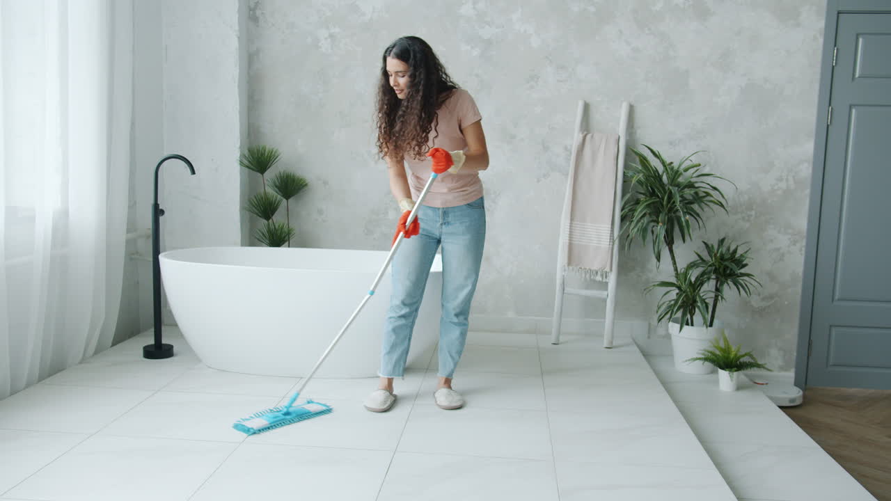 Woman mopping a bathroom floor