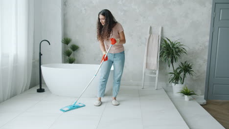 woman mopping a bathroom floor