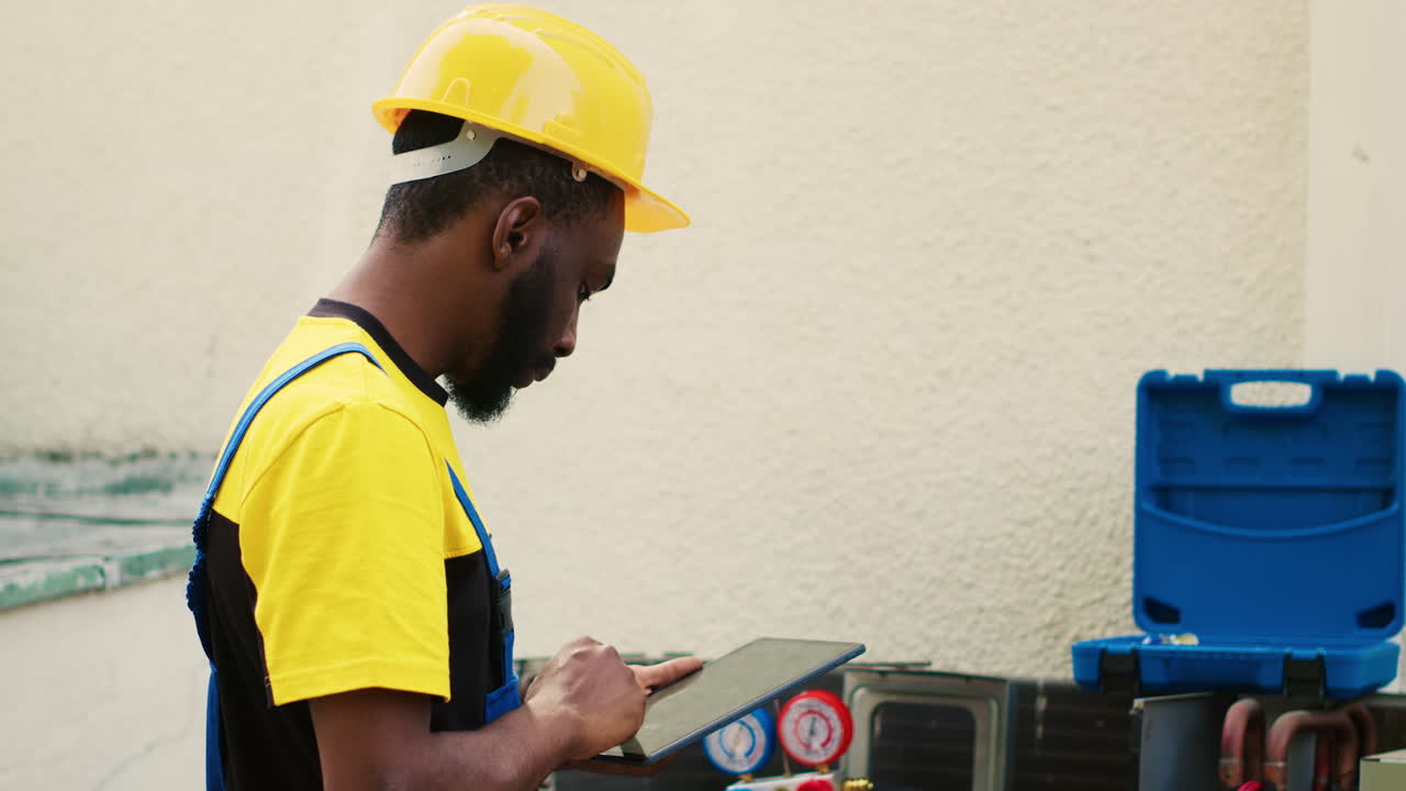 Happy technician using manifold meters