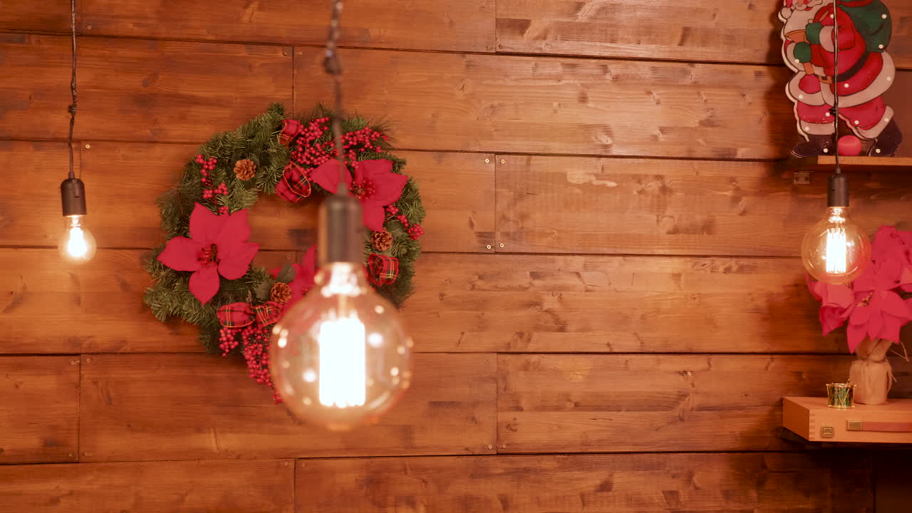 Christmas wreath and light bulbs on wood wall