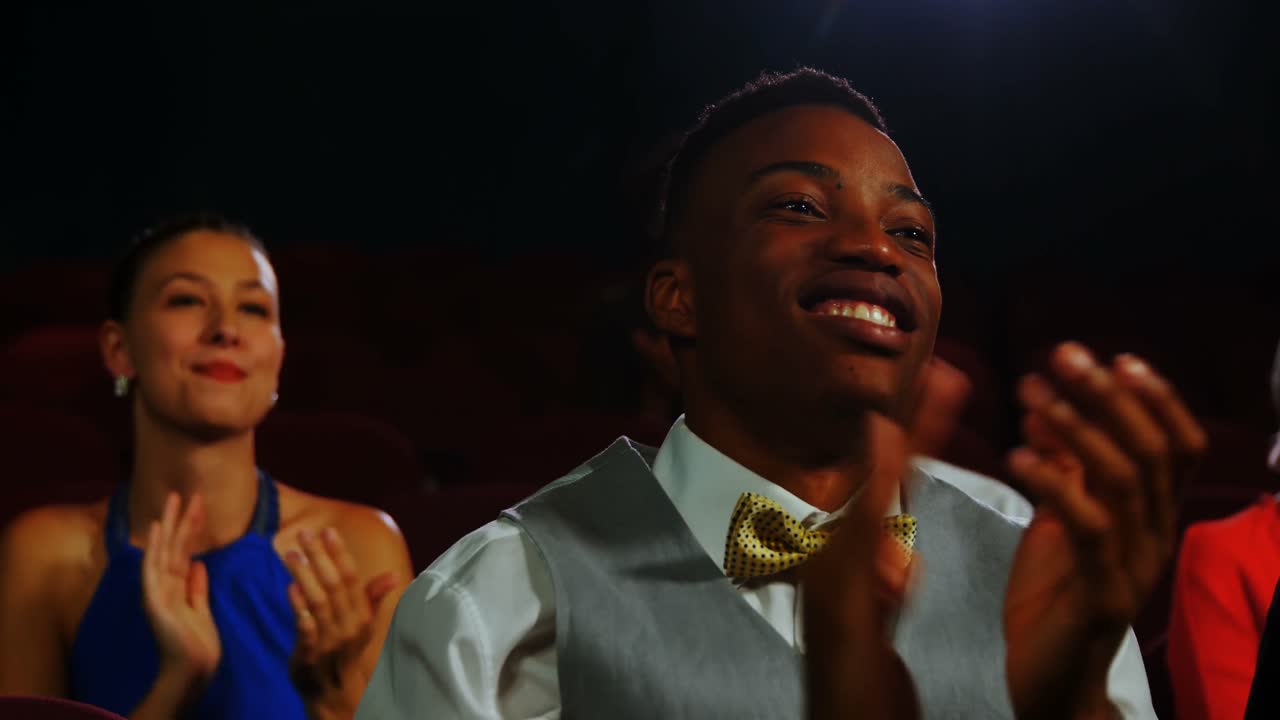 Group of people applauding while watching movie 4k
