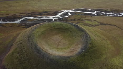 volcanic mountains and craters, glacial river and lonely vehicle in valley, drone aerial of majestic landscape of iceland