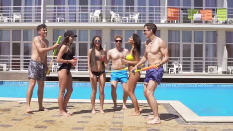 happy young cheerful friends dancing and having fun at the pool 4