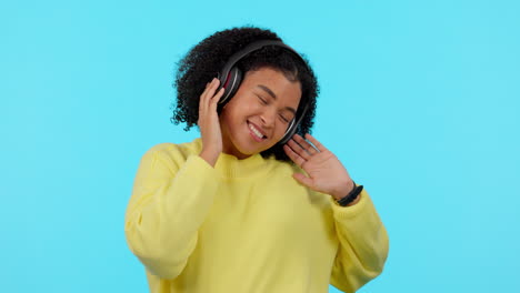 Young-woman,-headphones-and-dancing-in-studio