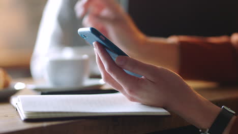 Hands,-phone-and-coffee-in-cafe-for-morning