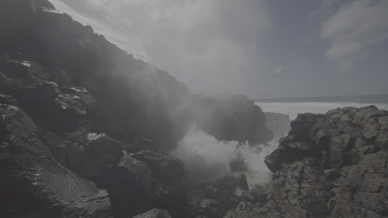 Powerful Ocean Waves Crashing Against Volcanic Coastline