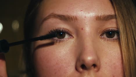 woman applying mascara