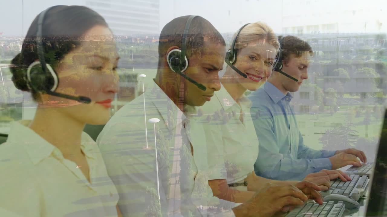 Call-center agents on headsets typing by glass with city, third agent smiling after noticing camera