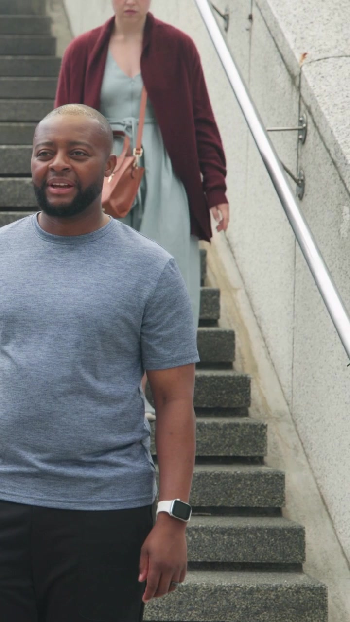 Man checking smartwatch then reacting to offered phone on stairs, tech bubbles linking devices