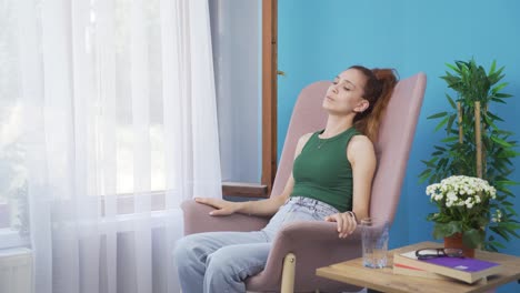 unwell woman watches out the window to relax.