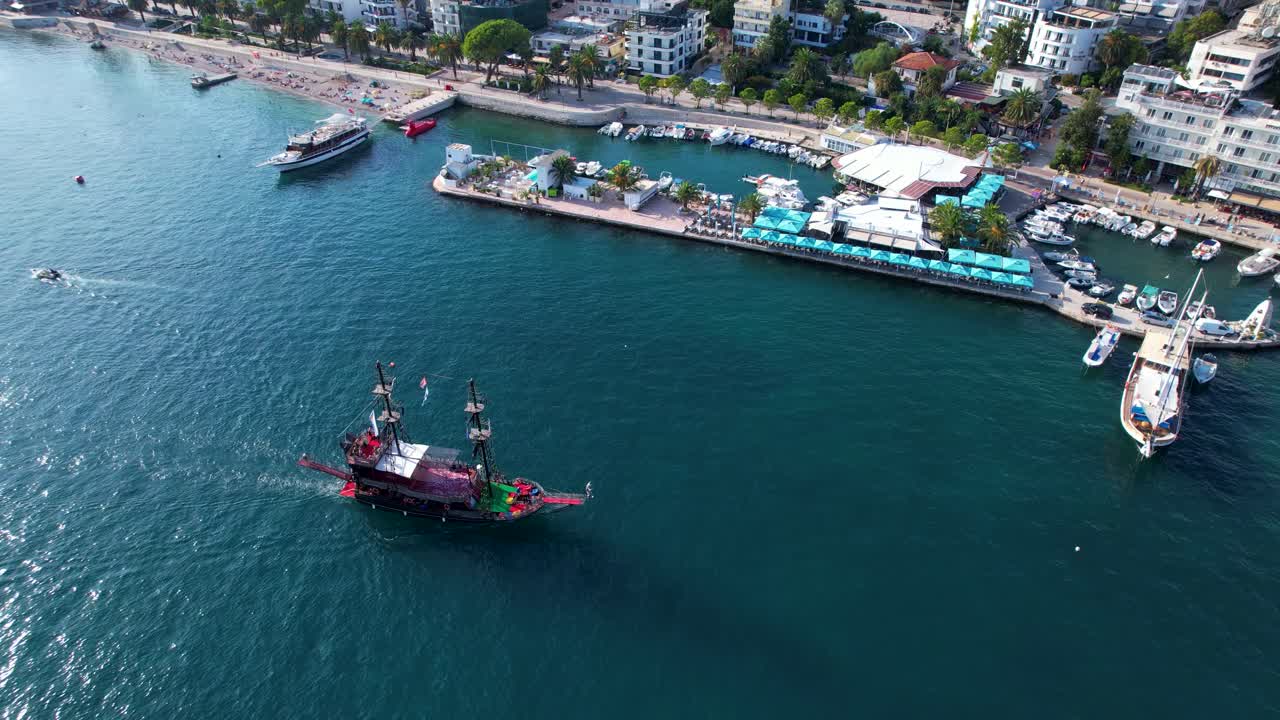 Pirate Ship in Saranda: Adored Tour Ships with Excited Tourists Explore the Seaside, Creating a Playful Scene at the Coastal City's Pier