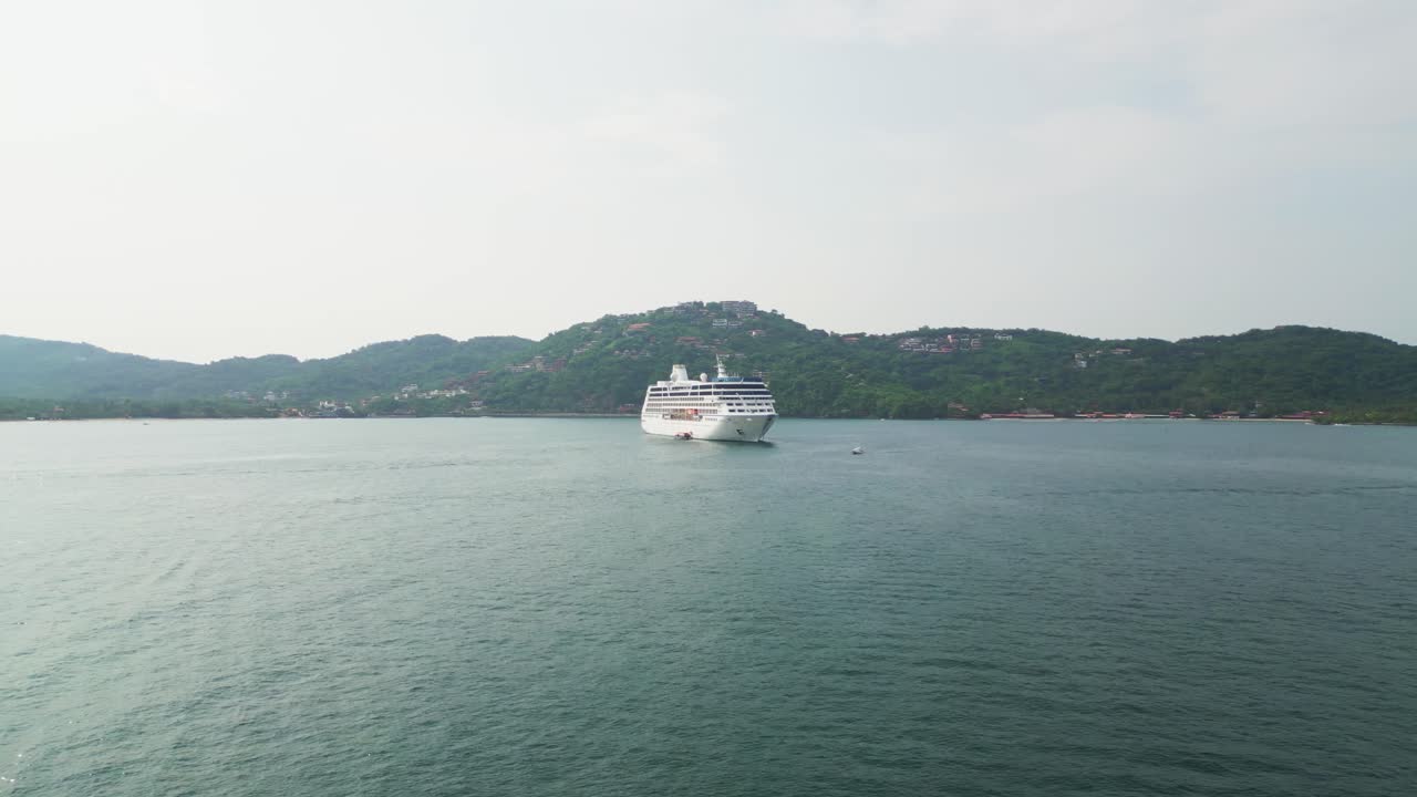 Cruise ship in Zihuatanejo Bay, in the Pacific Ocean, on vacation. 4K drone shot