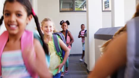 Smiling-school-kids-running-in-corridor