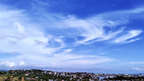 tilt-up angle revealing surigao city and the serene blue sky with cirrus clouds