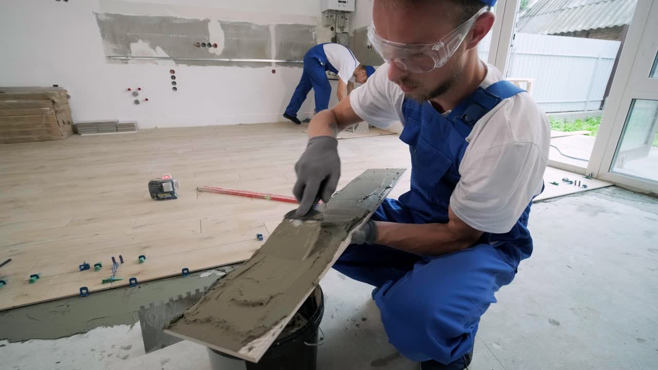 Construction, renovation, repair apartment. Installing ceramic floor tiles - measuring and cutting the pieces. Cuts tile. Tile cutting