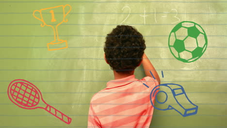animation of school items icons over biracial schoolboy writing on board in classroom