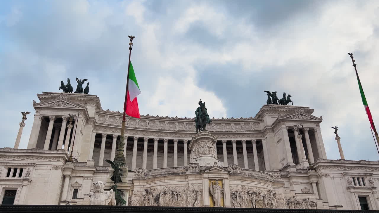 Inquadratura dall'alto verso il basso dell'Altare della Patria italiano con bandiera contro un cielo nuvoloso a Roma, Italia.