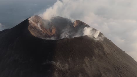volcano pacaya, close up view of crater emitting smoke and steam, high angle drone view