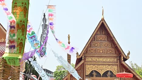 lanna flag blowing by the wind in wat phra singh temple in chiang rai province of thailand.