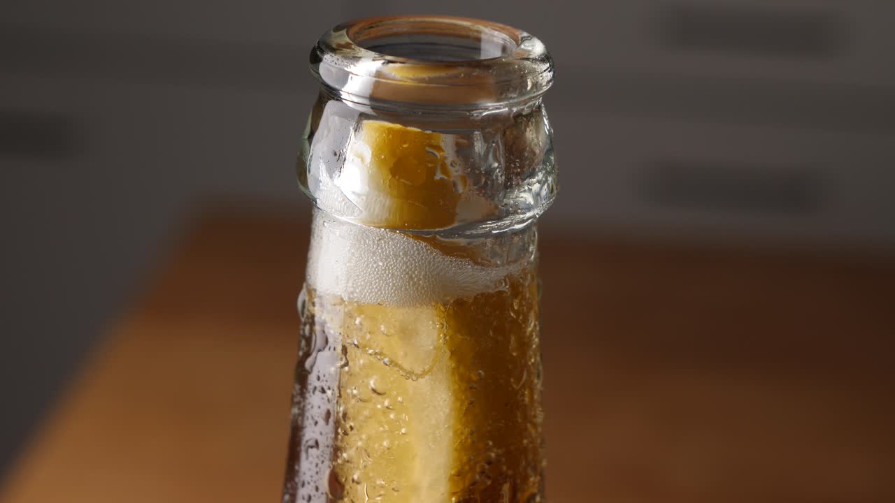 un limón burbujeante en una botella de cerveza de vidrio, un primerísimo plano