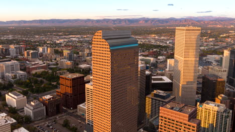 iconic wells fargo center in denver at sunset, aerial riser hyperlapse