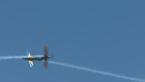 two brazilian stunt planes criss cross in the sky during a performance