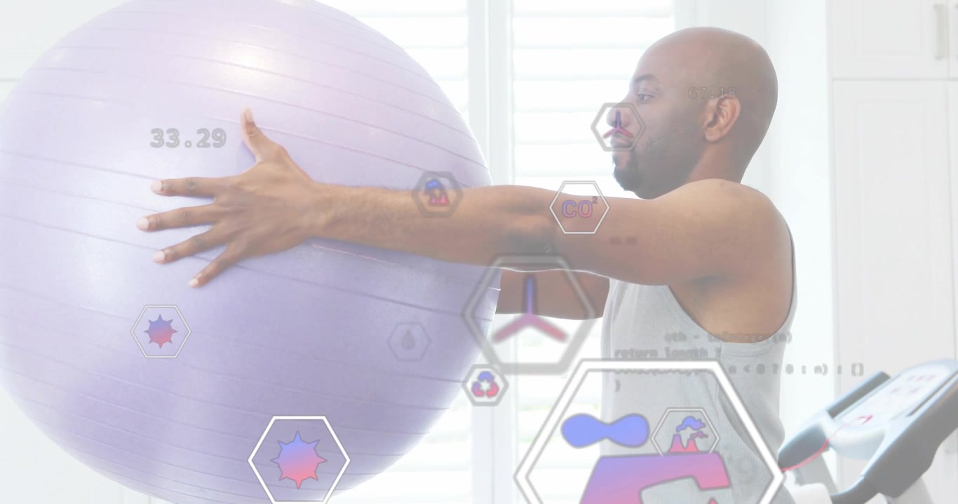 Male athlete gripping exercise ball and pushing forward in gym, displaying animated fitness metrics
