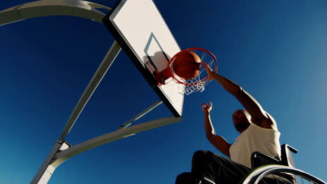 man playing wheelchair basketball outdoors