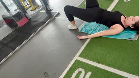 a person engages in floor exercises at the gym, lifting their body from the ground surface, embodying the ideals of fitness and vitality