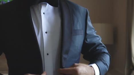 Groom-throws-suit-jacket-over-shoulders