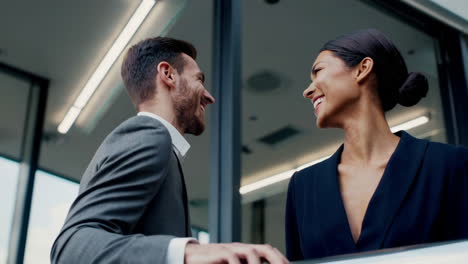 business professionals smiling and talking in a modern office building